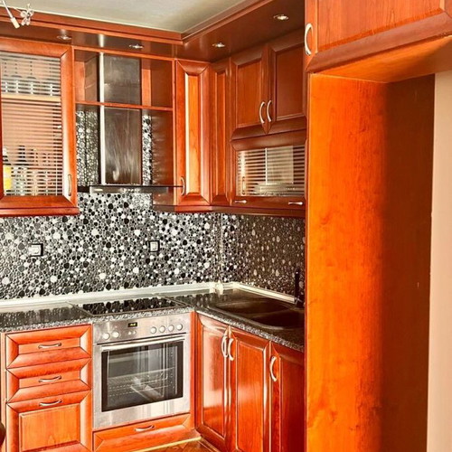 Corner kitchen made of solid cherry wood with extractor hood used