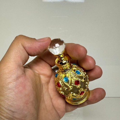Vintage Arabic perfume bottle with gold metal frame and stones