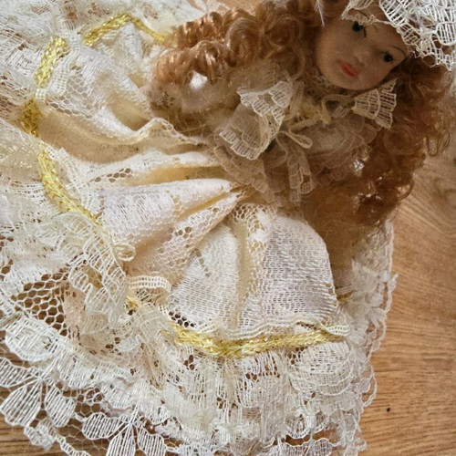 Glass bride doll like new with hat and lace