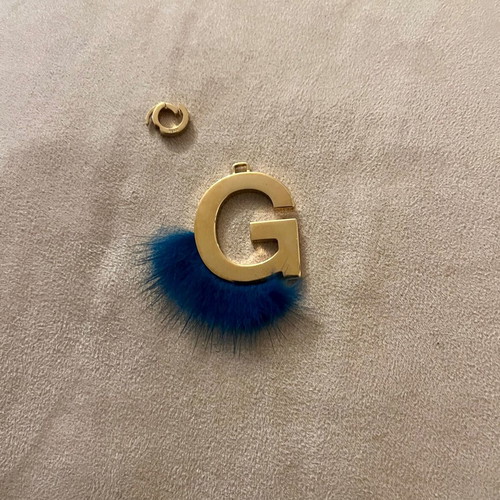 Fendi bag charm letter G with blue fur, like new