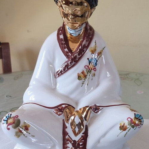 Vintage porcelain Buddha statue with gold details