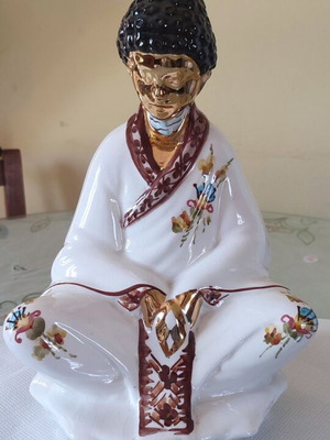 Vintage porcelain Buddha statue with gold details