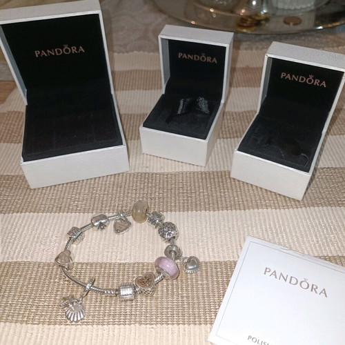 Pandora silver bracelet with 11 charms and collectible clasp, like new