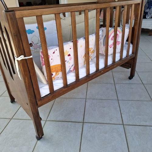 Wooden Baby Crib with Wheels and Protective Bumper, Walnut Color