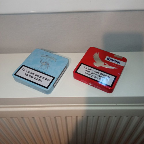 Camel and Winston collectible metal cigarette packs