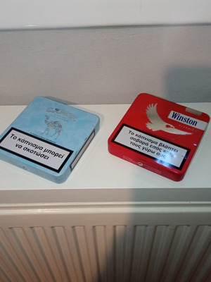 Camel and Winston collectible metal cigarette packs