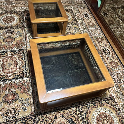 Set of two wooden square coffee tables with glass tops