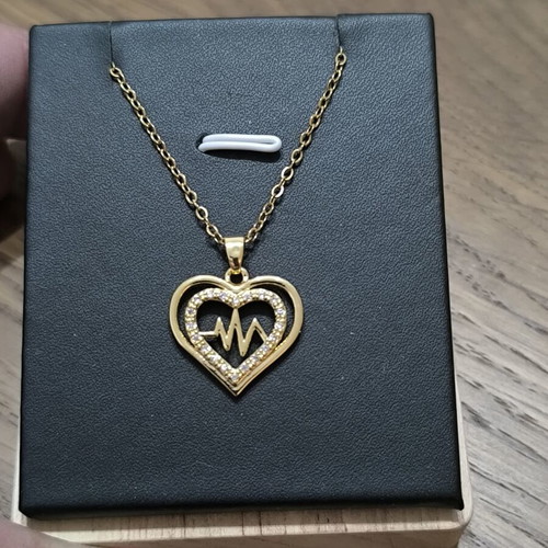Gold-tone heart necklace with pulse design and sparkling stones
