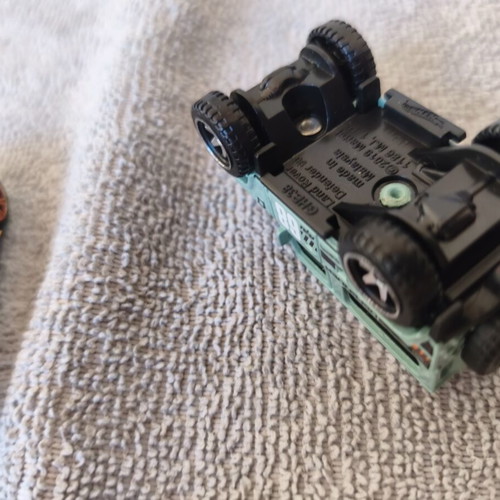 Land Rover Defender and Cord Camaro toy cars, set of 2