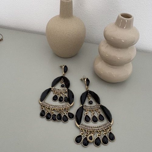 Dangling earrings used, large black and gold