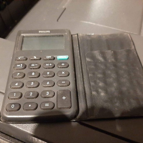 Philips pocket calculator used with vintage card holder