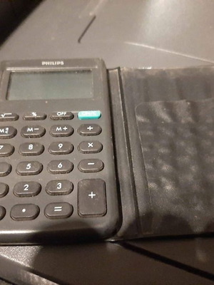 Philips pocket calculator used with vintage card holder
