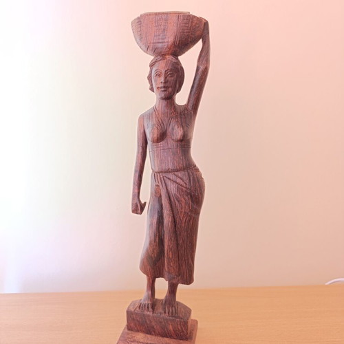 Rosewood figure of woman with basket from Bali, like new