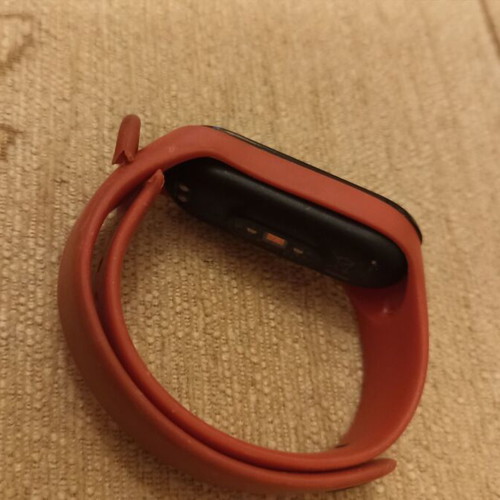 Mi Band smart watch used with charger, strap needs replacement