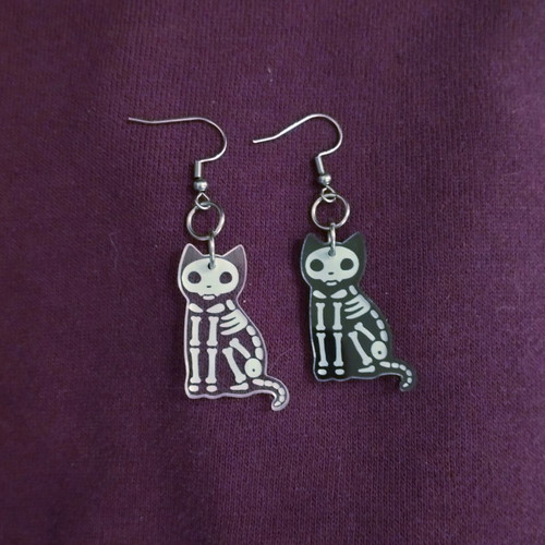 Skeleton cat earrings, pair, black and transparent
