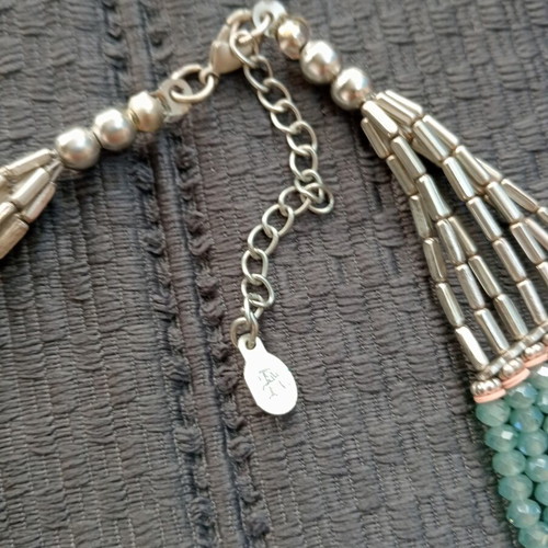 Accessorize multistrand necklace with plastic and glass beads