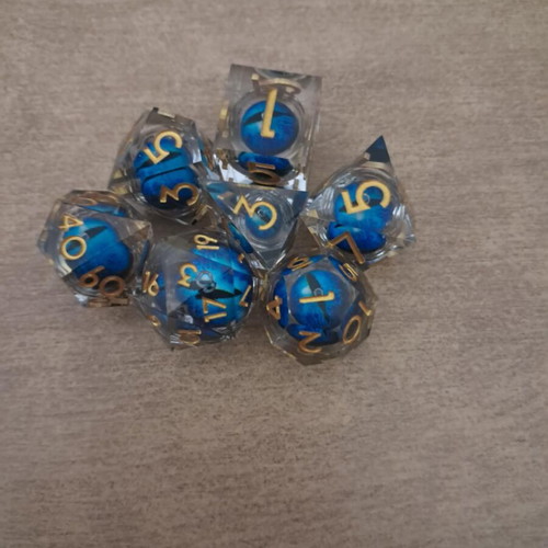 Blue moving dragon eye D&D dice set with bag