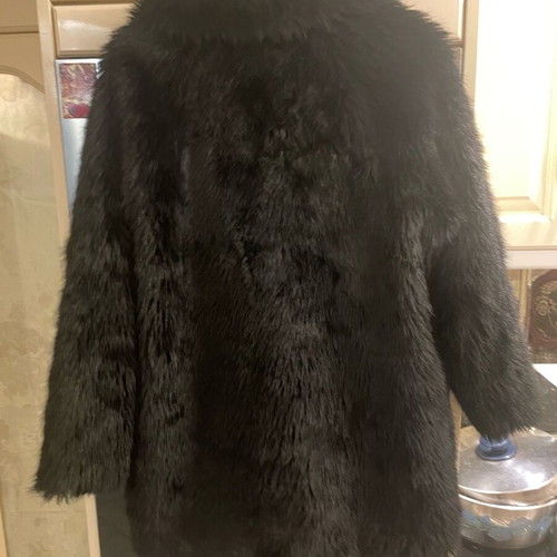 Long-haired fur used, black synthetic with pockets
