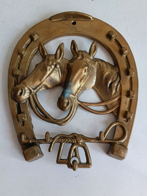 Vintage bronze horseshoe wall decoration with detailed horse heads