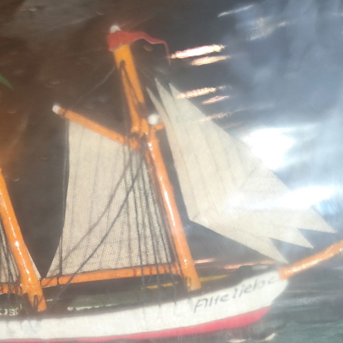 Ship in a bottle used with sealed top and wooden base