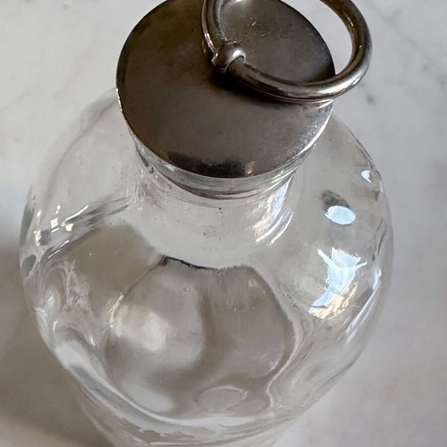 Glass apothecary bottle used with etched floral design
