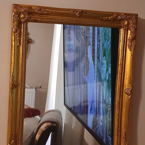 Wooden mirror with golden patina