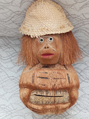 Handmade coconut shell money box with straw hat