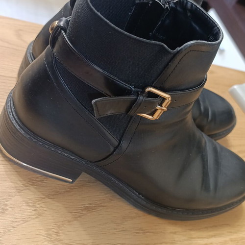 Black ankle Chelsea boots with buckle and gold details