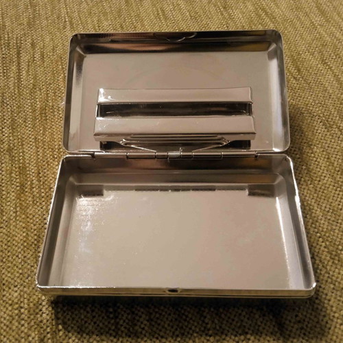 Tobacco case and metal cigarette roller used
