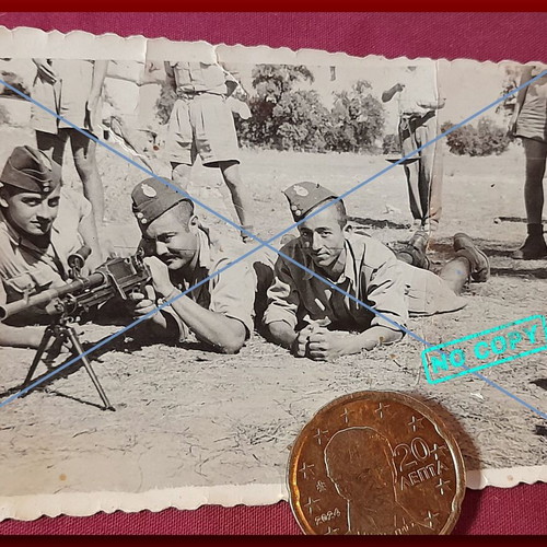 Vintage black and white photo of Greek soldiers prone with machine gun