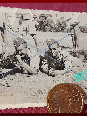 Vintage black and white photo of Greek soldiers prone with machine gun