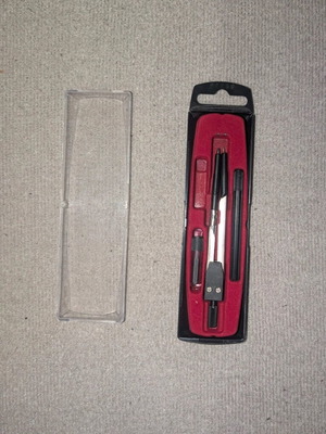 Compass with extender and tips used with case