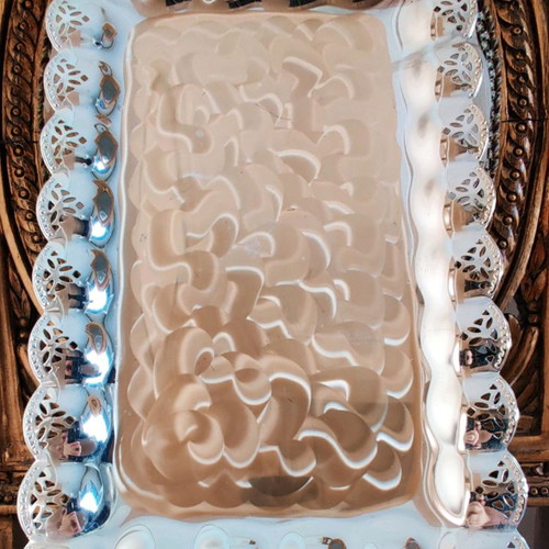 Metal serving platter used with beautiful decoration for desserts