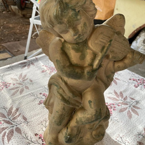 Decorative clay items in gold color, including Gorgoneion