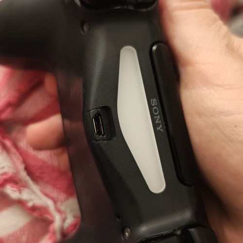 PlayStation controller used, somewhat worn but functional