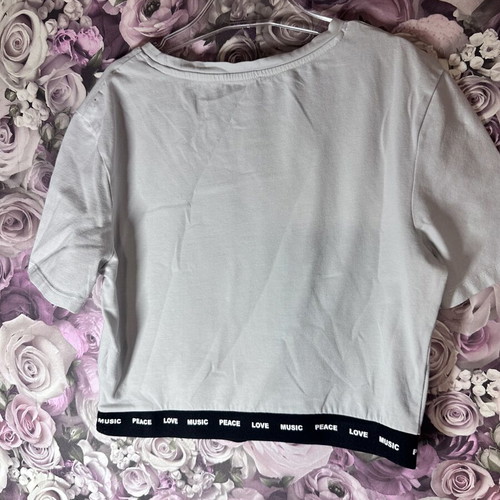White short-sleeve crop top with black elastic band, size M