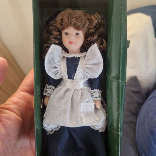Vintage porcelain doll in maid style, like new