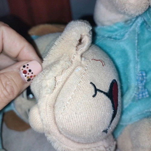 Stuffed animal dog in pajamas used with small seam opening