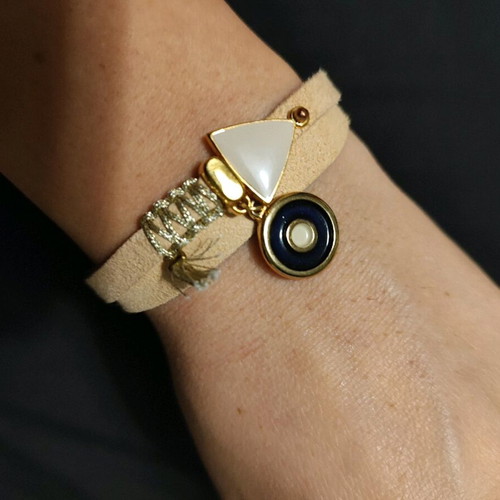 Bracelet with metal triangle and eye charm in light beige like new