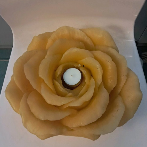 Large decorative rose candle used, yellow