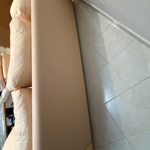 Three-seater fabric sofa used, light pink-peach color with side cushions