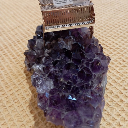 Vintage decorative piano on natural amethyst rock, gold-plated