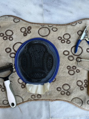 Pet grooming set with mat, glove brush, comb brushes and nail clipper