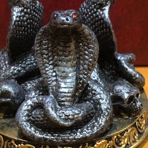 Decorative figurine with snakes and skulls