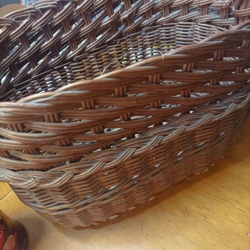 Handmade dark brown wicker basket with high arched handle