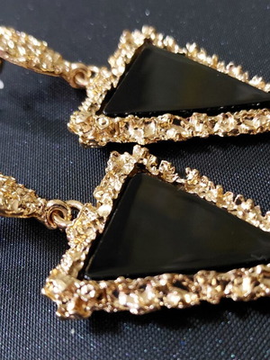 Black geometric earrings with gold details