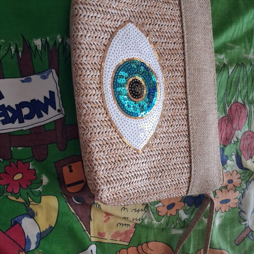 Straw bag wristlet like new, beige with eye design