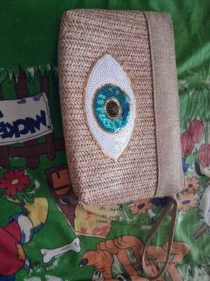 Straw bag wristlet like new, beige with eye design