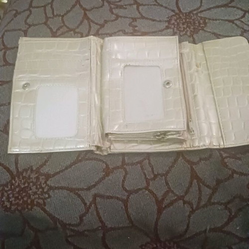 Beige wallet used with card slots and bill compartment