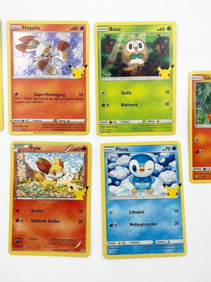 Pokémon 25th Anniversary collectible pack with 7 cards and 2 booster packs